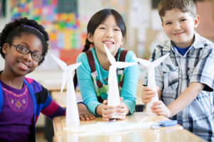 elementary students displaying wind turbine models