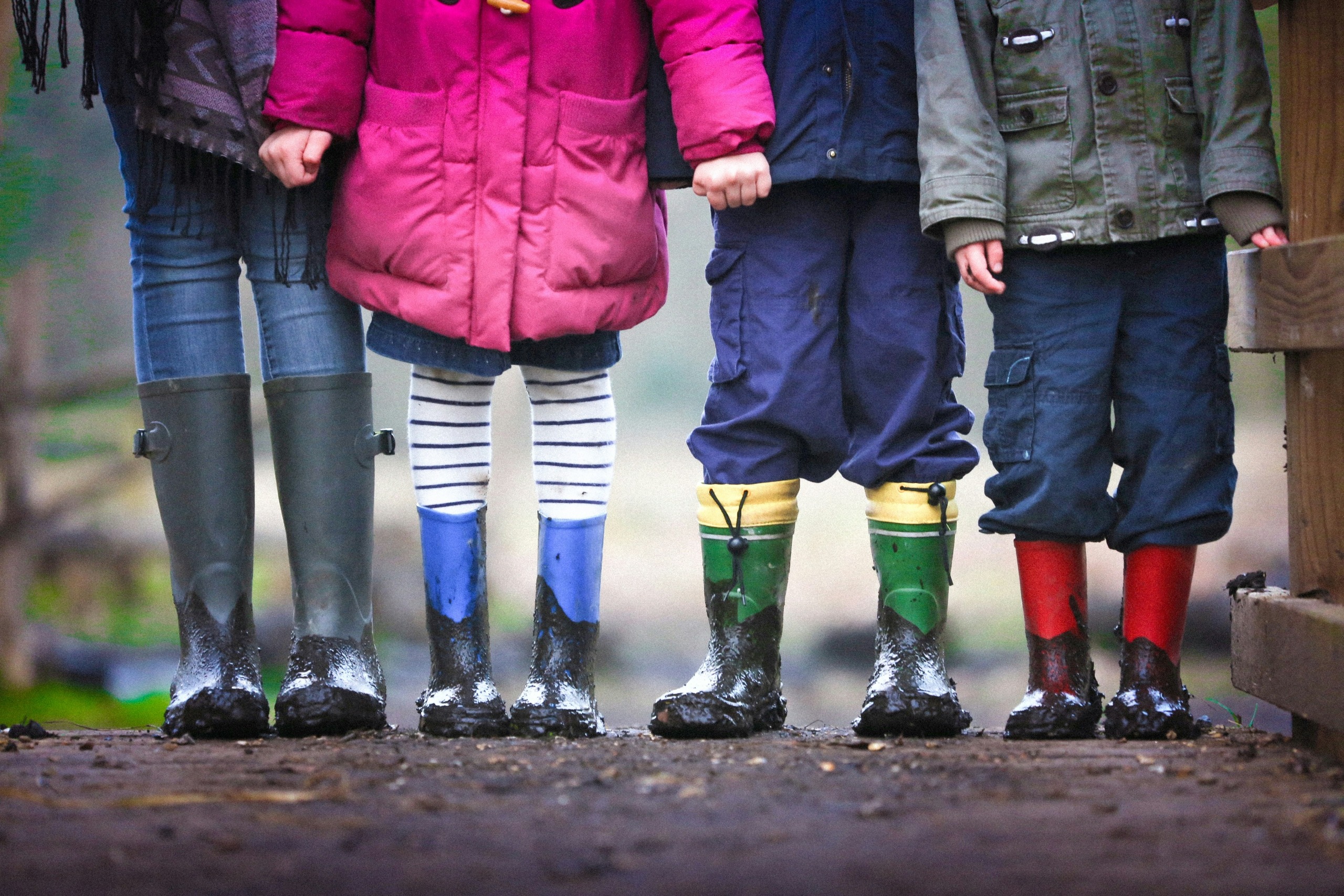 four children standing on dirt during daytime - photo by ben wicks