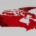 3D rendered map of Canada in red with raised terrain features on a light grey background.