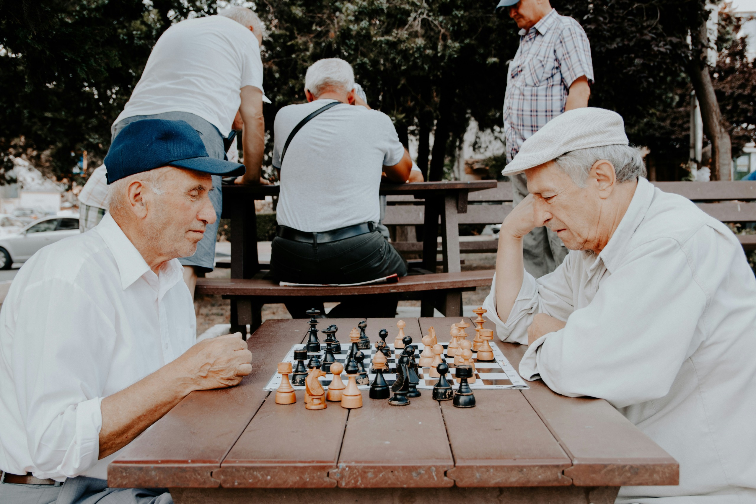 two men playing chess - photo by vlad sargu