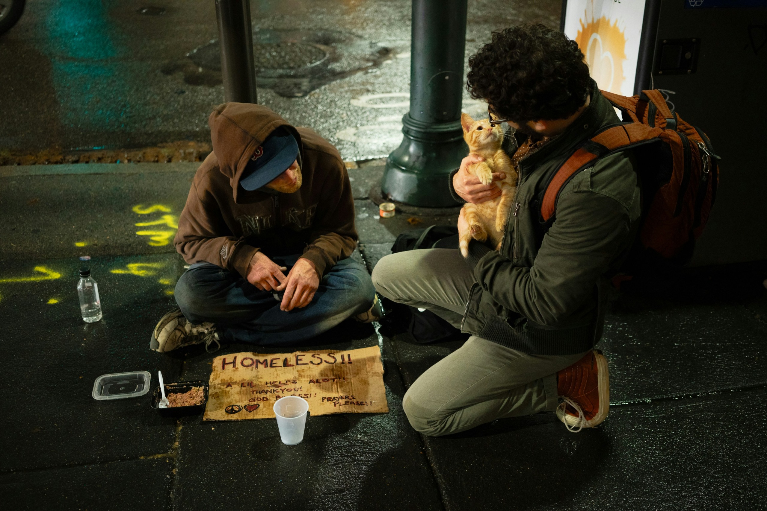 two men sitting on road - photo by zac durant