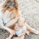 woman and baby sitting on the ground - photo by katie emslie